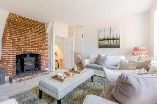 a living room with a couch and a fireplace at 4 Bed in Cley oc-m33116 in Cley next the Sea