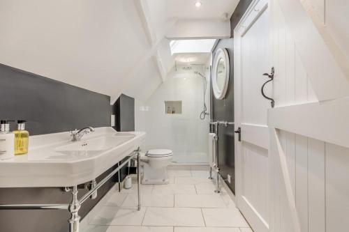 a white bathroom with a sink and a toilet at 4 Bed in Cley oc-m33116 in Cley next the Sea