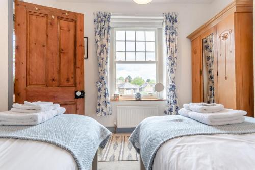 two beds in a room with a window at 3 Bed in Crich oc-dcivyd in Crich
