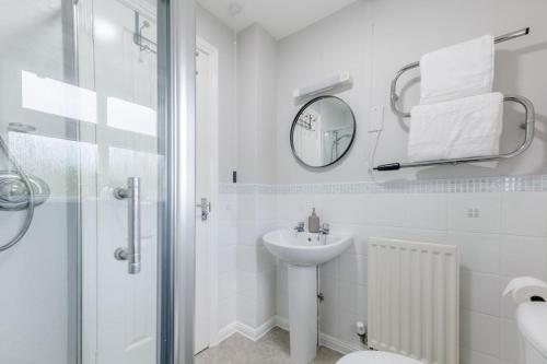 a white bathroom with a sink and a mirror at 2 Bed in Alnwick oc-e33447 in Embleton