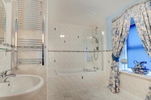 a bathroom with a tub and a sink and a shower at 3 Bed in Hawes oc-ds1009 in Hawes