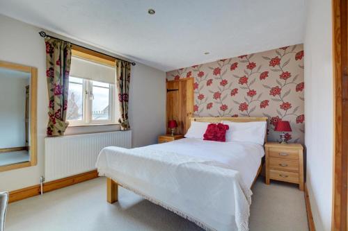 a bedroom with a white bed and a window at 2 Bed in Bodham oc-1303 in Bodham