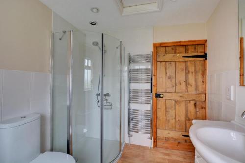 a bathroom with a shower and a toilet and a sink at 2 Bed in Bodham oc-1303 in Bodham
