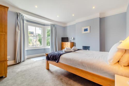 a bedroom with a large bed and a window at 4 Bed in Southwold oc-l29092 in Southwold