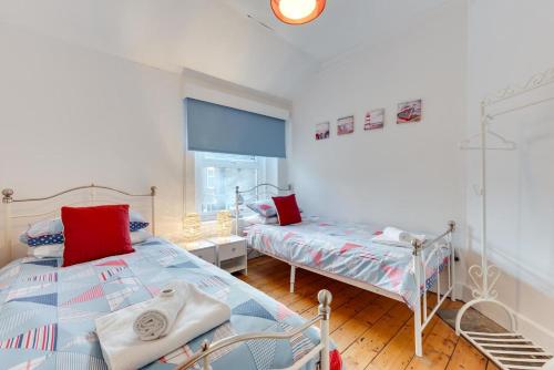 a bedroom with two beds and a window at 3 Bed in Broadstairs oc-th006 in Broadstairs