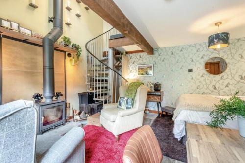 a living room with a fireplace and a bedroom at 1 Bed in Reeth oc-t29540 in Reeth