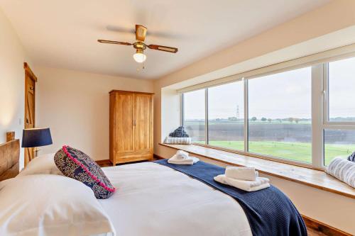 a bedroom with a bed and a large window at 3 Bed in Outwell oc-b28260 in Upwell