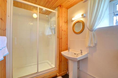 a bathroom with a shower and a sink at 3 Bed in Pwllheli oc-wag486 in Bryncroes