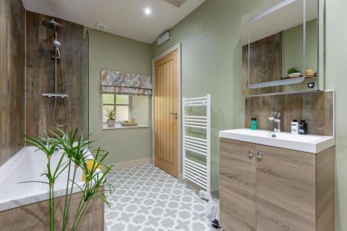 a bathroom with a tub and a sink and a shower at 1 Bed in Wycliffe oc-t29946 in Wycliffe