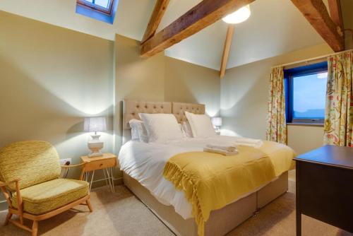 a bedroom with a bed and a chair and a window at 3 Bed in Holme-on-Spalding-Moor oc-vy213 in Holme upon Spalding Moor