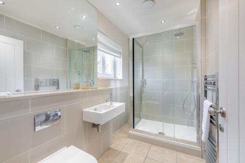 a bathroom with a toilet and a sink and a shower at 2 Bed in Bamburgh oc-gd0462 in Bamburgh