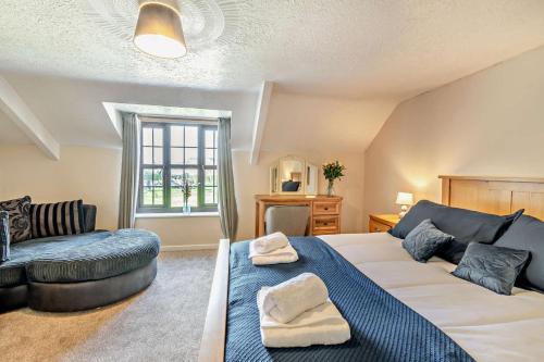 a bedroom with a large bed and a couch at 3 Bed in Stackpole oc-c27398 in Stackpole Elidor
