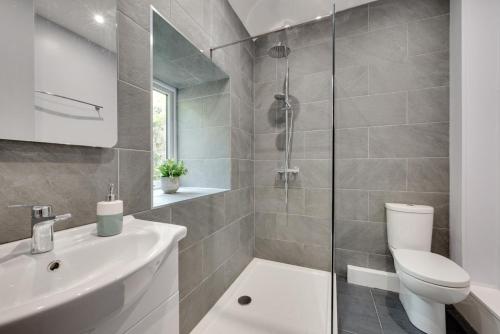 a bathroom with a toilet and a sink and a shower at 3 Bed in Llanllechid oc-wag712 in Llanllechid