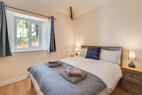 a bedroom with a large bed with a window at 3 Bed in Llanllechid oc-wag712 in Llanllechid