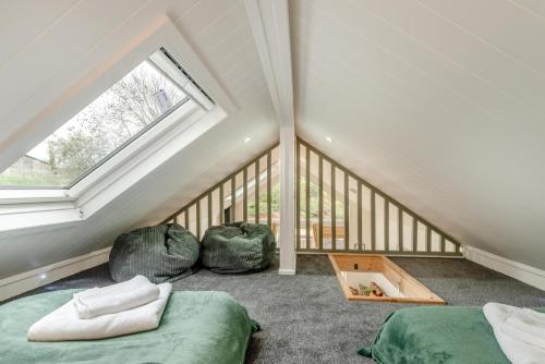 a attic room with two beds and a window at 2 Bed in Mouswald oc-b33444 in Mouswald