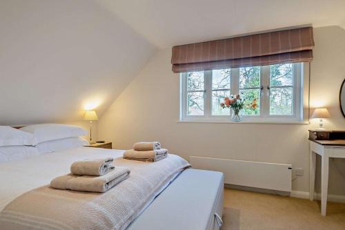 a bedroom with a bed and a window with towels at 2 Bed in Wickhambrook oc-b30507 in Wickhambrook