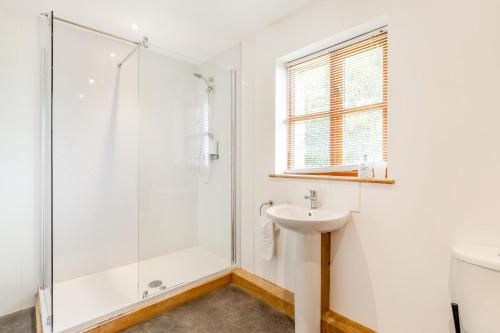 a bathroom with a shower and a sink at 3 Bed in Shebbear oc-l32583 in Shebbear