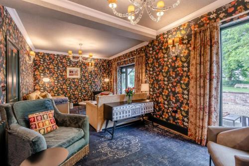 a living room with floral wallpaper and a piano at 3 Bed in Thelwall oc-c29954 in Warrington