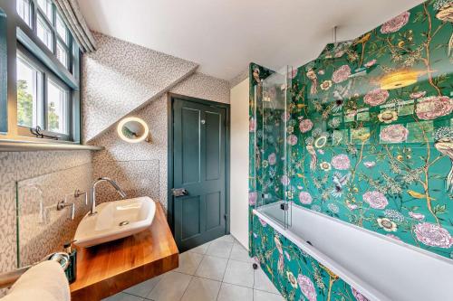 a bathroom with a tub and a sink and a shower at 3 Bed in Thelwall oc-c29954 in Warrington