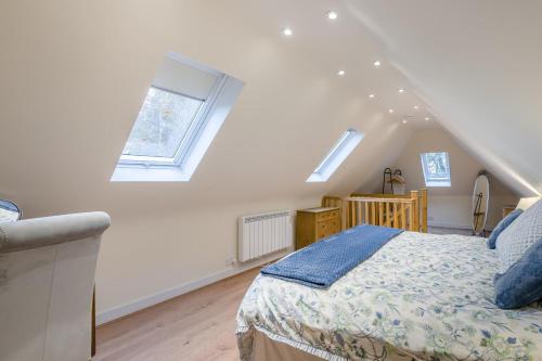 a white bedroom with a bed and a window at 1 Bed in Rolvenden oc-c33657 in Rolvenden