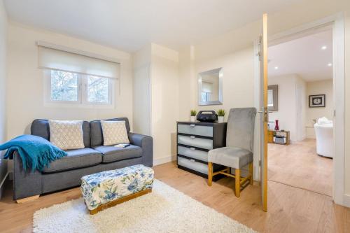 a living room with a couch and a chair at 1 Bed in Rolvenden oc-c33657 in Rolvenden