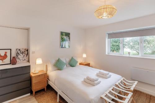 a bedroom with a white bed with towels on it at 3 Bed in Camber oc-s27568 in Camber