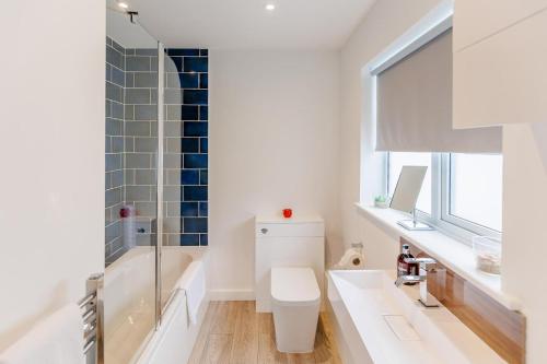 a bathroom with a toilet and a tub and a sink at 3 Bed in Camber oc-s27568 in Camber