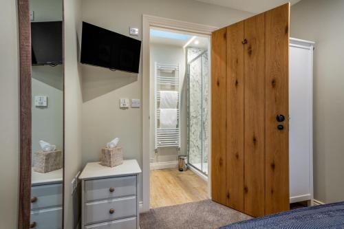 a bedroom with a large wooden door and a television at 2 Bed in Castleton oc-p34012 in Castleton