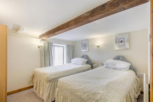 a bedroom with two beds and a window at 2 Bed in Smallburgh oc-m33732 in Dilham
