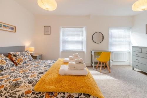 a bedroom with a bed with towels on it at 2 Bed in Tenby oc-pw1031 in Tenby