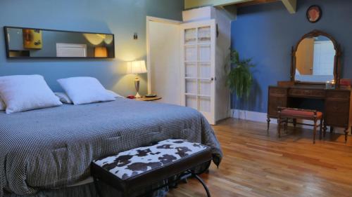 a bedroom with a bed and a dresser and a mirror at Artist Chalet in Flagstaff