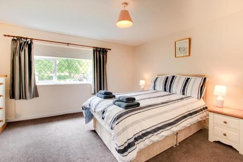 a bedroom with a bed and a window at 2 Bed in Dennington oc-b28010 in Dennington
