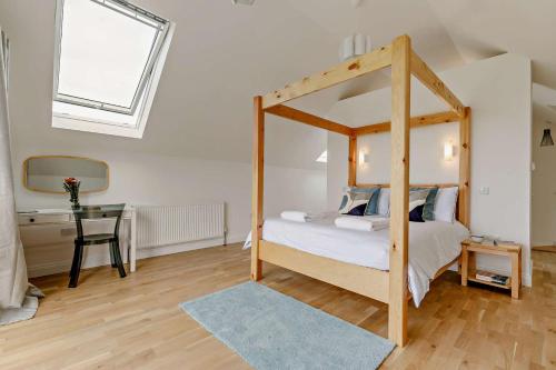a bedroom with a canopy bed and a desk at 5 Bed in St. Merryn oc-t27899 in Saint Merryn