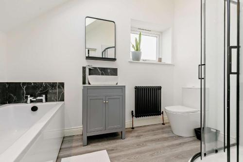 a bathroom with a sink and a mirror and a toilet at 5 Bed in St. Merryn oc-t27899 in Saint Merryn