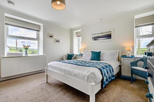 a bedroom with a bed and two windows at 3 Bed in Treknow oc-h29194 in Treknow