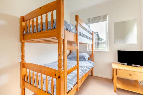 a bedroom with a bunk bed and a desk at 3 Bed in St. Merryn oc-k30138 in Saint Merryn