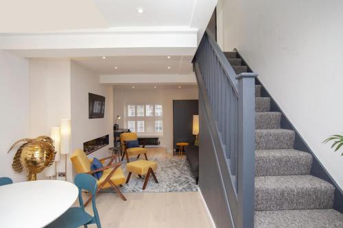 a staircase in a living room with a table and chairs at 2 Bed in Bath oc-bhr8 in Bath