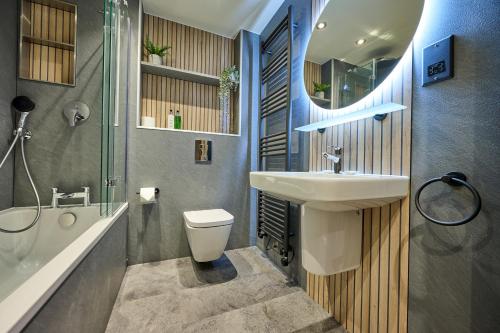 a bathroom with a sink and a toilet and a shower at Riverside Park 5 in Keswick
