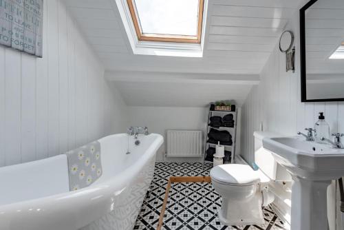 a bathroom with a tub and a toilet and a sink at 3 Bed in Port Talbot oc-b30321 in Port Talbot