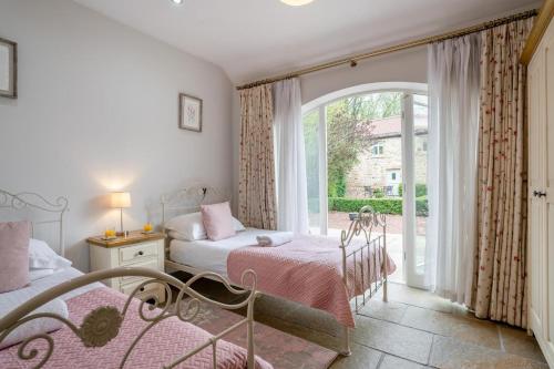 a bedroom with two beds and a large window at 2 Bed in Crakehall oc-b30354 in Crakehall