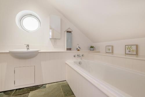 a white bathroom with a sink and a tub at 5 Bed in Rock oc-m33185 in Roche