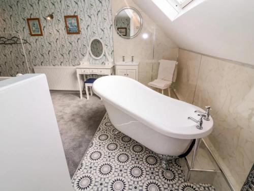 a bathroom with a white tub and a sink at 3 Bed in Ripon oc-t33753 in Ripon