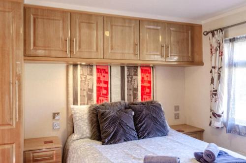 a bedroom with a bed with wooden cabinets at 2 Bed in Stepaside oc-pw9184 in Stepaside