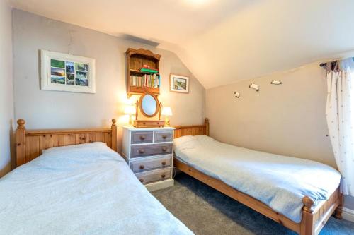 two twin beds in a bedroom with a mirror at 2 Bed in Castleton oc-o30120 in Castleton