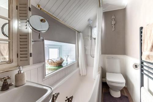 a bathroom with a sink and a toilet and a mirror at 2 Bed in Castleton oc-o30120 in Castleton