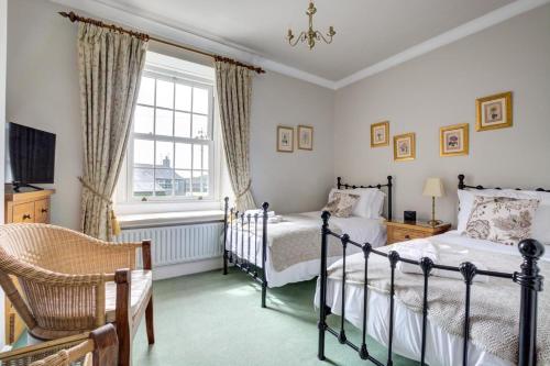 a bedroom with two beds and a window at 5 Bed in Kettlewell oc-ds257 in Kettlewell