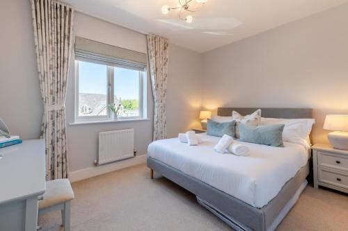 a bedroom with a large white bed and a window at 2 Bed in Beadnell oc-s30910 in Beadnell