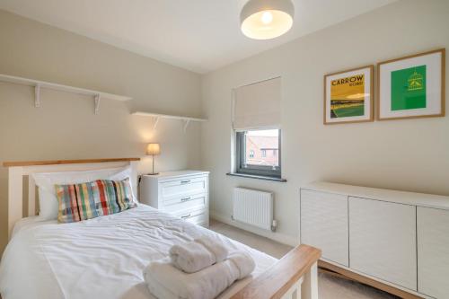 a bedroom with a white bed and a window at 2 Bed in Mundesley oc-r31875 in Mundesley
