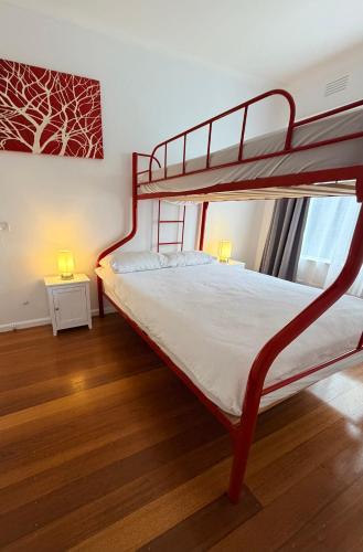 a bedroom with a bunk bed with two lamps at Genesta House in Cowes
