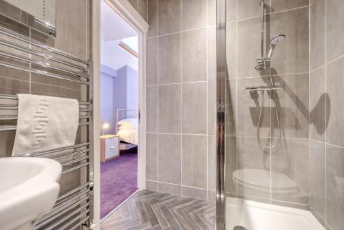 a bathroom with a shower and a sink at 1 Bed in Tenby oc-w28986 in Tenby